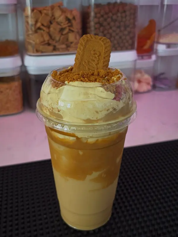 Deluxe cookie butter cloud in a tall cup with a Lotus Biscoff cookie on top