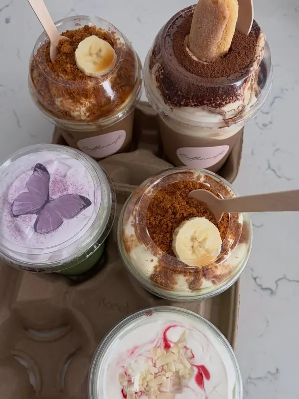 Lavender matcha topped with lavender cream and an edible purple butterfly wafer